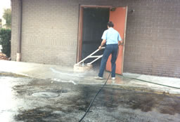 Cleaning an employee grease spill at the back door of a restaurant
 .